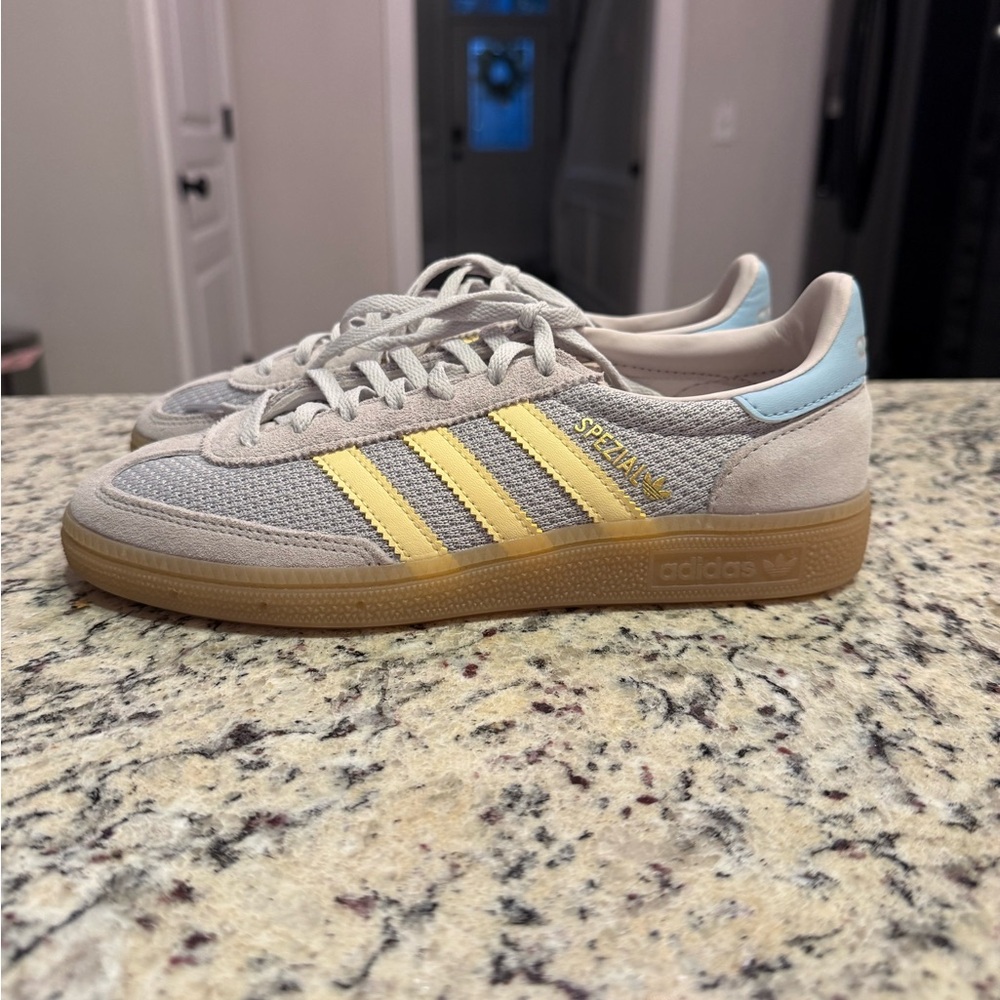 adidas beige sneakers with yellow stripes and light blue heel
